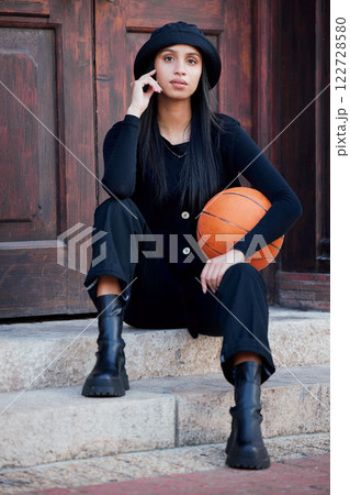 Fashion model, influencer and young woman with basketball posing on steps in urban city. Portrait of trendy, stylish and cool person with funky attitude, grunge personality and modern black clothes 122728580