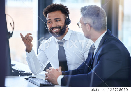 Call center agent or telemarketing employee consulting a business man and talking about company growth. Happy male customer service employee in training with an HR manager at the office 122728650