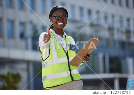 Thumbs up, success and motivation by health and safety construction worker thank you for support of goal or vision. Happy black woman holding building inspection list, showing winning, trust sign Thumbs up, success and motivation by health and safety construction worker thank you for support of goal or vision. Happy black woman holding building inspection list, showing winning, trust sign 122728796