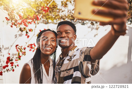 Man and woman love taking a selfie portrait together as a couple smiling during summer under relaxing sun. Happy, smile and free boyfriend and young girlfriend take pictures on phone for social media Man and woman love taking a selfie portrait together as a couple smiling during summer under relaxing sun. Happy, smile and free boyfriend and young girlfriend take pictures on phone for social media 122728921