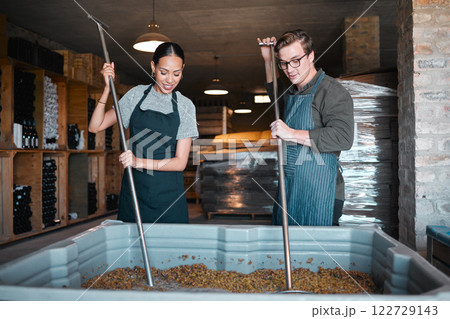 Production, manufacturing worker and teamwork in wine industry and labor press tool for fermentation of grape fruit alcohol. Sommelier people working in winery, distillery or warehouse at a vineyard Production, manufacturing worker and teamwork in wine industry and labor press tool for fermentation of grape fruit alcohol. Sommelier people working in winery, distillery or warehouse at a vineyard 122729143