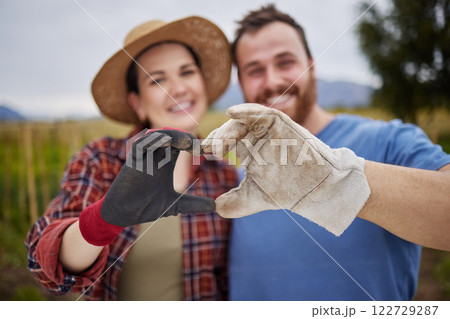 Farmer or gardener couple showing love heart sign with their hands outdoors on an organic or sustainable farm. Happy and excited activists support sustainability or organic farming Farmer or gardener couple showing love heart sign with their hands outdoors on an organic or sustainable farm. Happy and excited activists support sustainability or organic farming 122729287