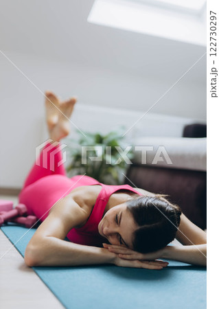 Stretching, yoga and woman on a living room floor for training, exercise or mental health at home. Legs, stretch and lady with flexible fitness or pilates workout for balance, meditation or wellness Stretching, yoga and woman on a living room floor for training, exercise or mental health at home. Legs, stretch and lady with flexible fitness or pilates workout for balance, meditation or wellness 122730297