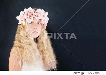 Cute blond child girl with fashion flower decor on black background portrait Cute blond child girl with fashion flower decor on black background portrait 122730538