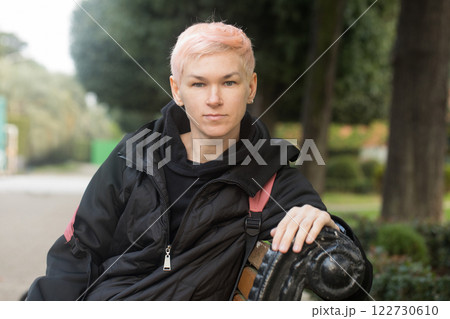 Calm middle-aged woman with short hair and a black jacket outdoors Calm middle-aged woman with short hair and a black jacket outdoors 122730610