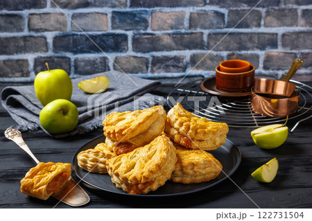 puff pastry apple turnovers on a plate 122731504