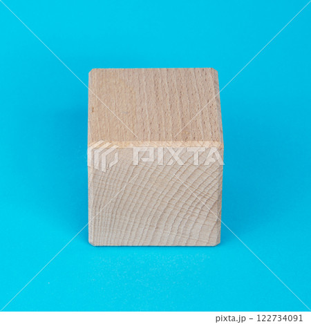 Empty clear wooden cube on blue background 122734091