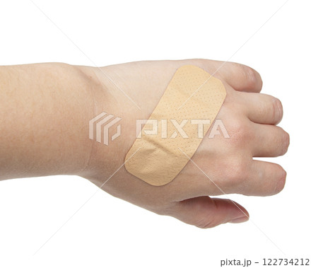 Medical big elastic plaster on woman hand isolated on the white background 122734212