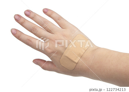 Medical big elastic plaster on woman hand isolated on the white background 122734213