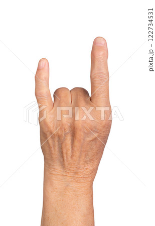 Elderly hand making rock sign, fingers forming horn gesture, symbolizing music, concert energy, and 122734531