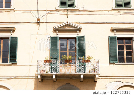Close view on the facade of a traditional building in Italy. Beautiful house with balcony in old town. Traveling Europe concept, High quality photo 122735333