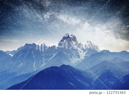 Fantastic starry sky. Autumn landscape and snow-capped peaks. Main Caucasian Ridge. Mountain View from Mount Ushba Meyer, Georgia. Europe Fantastic starry sky. Autumn landscape and snow-capped peaks. Main Caucasian Ridge. Mountain View from Mount Ushba Meyer, Georgia. Europe 122735363