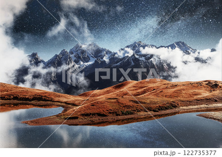 Fantastic starry sky on mountain lake Koruldi. Picturesque night Upper Svaneti, Georgia Europe. Caucasus mountains 122735377