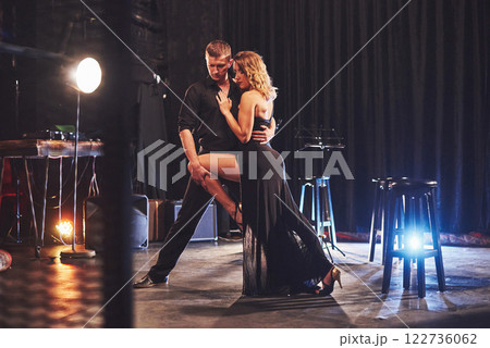 Skillful dancers performing in the dark room under the light 122736062