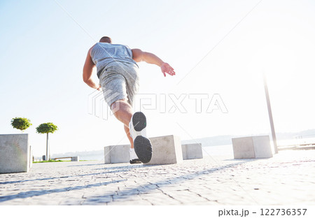 man runner doing stretching exercise, preparing for morning workout in the park man runner doing stretching exercise, preparing for morning workout in the park 122736357