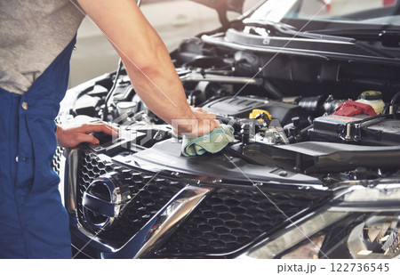 Picture showing muscular car service worker repairing vehicle Picture showing muscular car service worker repairing vehicle 122736545
