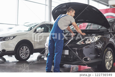Picture showing muscular car service worker repairing vehicle Picture showing muscular car service worker repairing vehicle 122736549