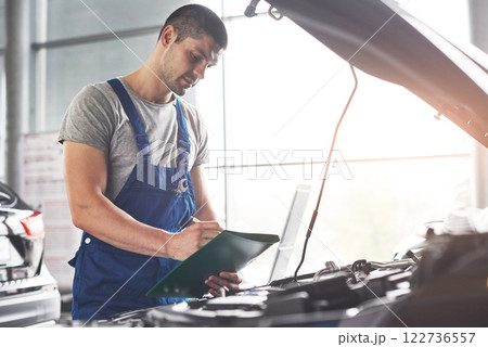 Picture showing muscular car service worker repairing vehicle 122736557