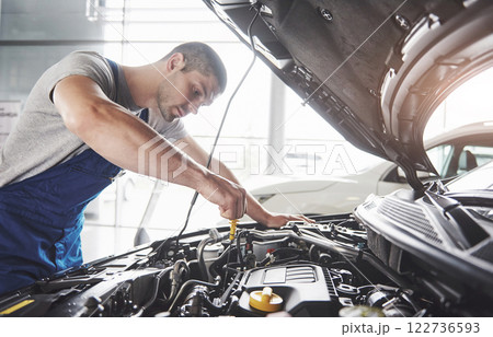 Picture showing muscular car service worker repairing vehicle Picture showing muscular car service worker repairing vehicle 122736593