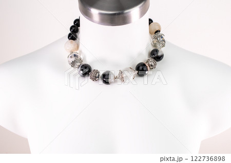 Unique necklace on a white mannequin, promotional photo for an online vintage and handmade jewelry store Unique necklace on a white mannequin, promotional photo for an online vintage and handmade jewelry store 122736898