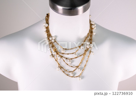 Unique necklace on a white mannequin, promotional photo for an online vintage and handmade jewelry store 122736910