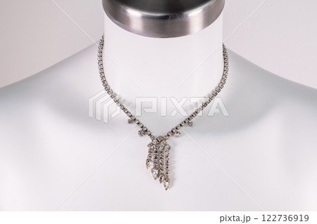 Unique necklace on a white mannequin, promotional photo for an online vintage and handmade jewelry store 122736919