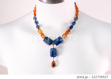 Unique necklace on a white mannequin, promotional photo for an online vintage and handmade jewelry store Unique necklace on a white mannequin, promotional photo for an online vintage and handmade jewelry store 122736927