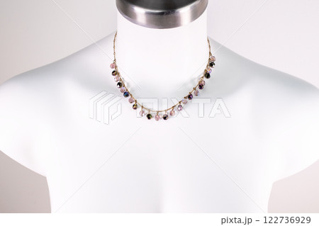 Unique necklace on a white mannequin, promotional photo for an online vintage and handmade jewelry store 122736929