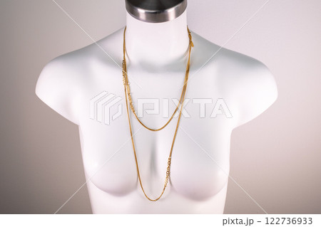 Unique necklace on a white mannequin, promotional photo for an online vintage and handmade jewelry store Unique necklace on a white mannequin, promotional photo for an online vintage and handmade jewelry store 122736933