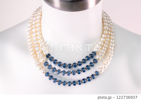 Unique necklace on a white mannequin, promotional photo for an online vintage and handmade jewelry store 122736937