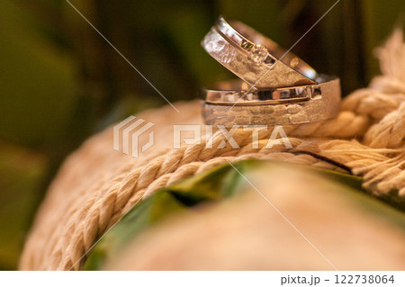Beautiful Elegant Wedding Rings Displayed Beautifully on a Textured Twine Base Here Beautiful Elegant Wedding Rings Displayed Beautifully on a Textured Twine Base Here 122738064