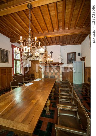 An Elegant Conference Room Featuring Beautiful Wooden Decor and an Exquisite Chandelier 122738066