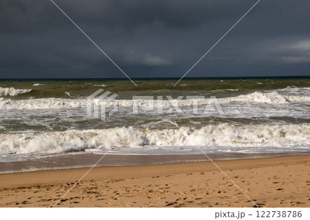 Empty wild sandy beach, Atlantic Ocean seascape, sea waves, beautiful cloudscape, dramatic landscape, travel content, Lisbon, Portugal 122738786