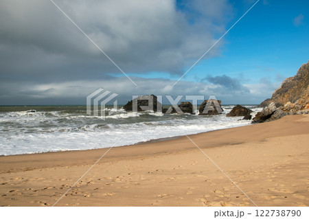 Empty wild sandy beach, Atlantic Ocean seascape, sea waves, beautiful cloudscape, dramatic landscape, travel content, Lisbon, Portugal Empty wild sandy beach, Atlantic Ocean seascape, sea waves, beautiful cloudscape, dramatic landscape, travel content, Lisbon, Portugal 122738790