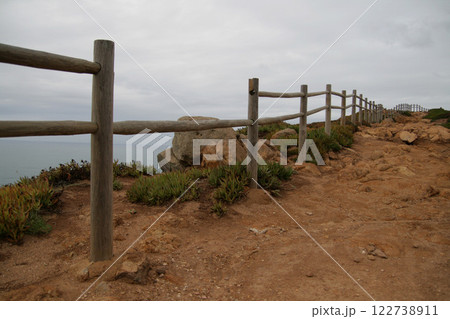 Panorama of the ocean coast and rock bay, Atlantic Ocean in winter, stormy sea waves with white lambs roll ashore with sheer rocks, beautiful cloudscape, dramatic landscape, gloomy seascape Panorama of the ocean coast and rock bay, Atlantic Ocean in winter, stormy sea waves with white lambs roll ashore with sheer rocks, beautiful cloudscape, dramatic landscape, gloomy seascape 122738911