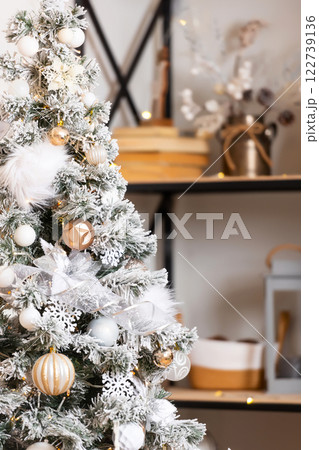 New Year tree with snow on branches with black shelf. decoration in the room with a Christmas tree 122739136