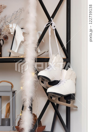 white winter skates on the shelf. ice skates on the decoration in the photo studio white winter skates on the shelf. ice skates on the decoration in the photo studio 122739138