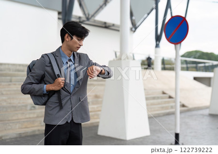 Business professional checking time at transport hub urban environment lifestyle business concept Business professional checking time at transport hub urban environment lifestyle business concept 122739222