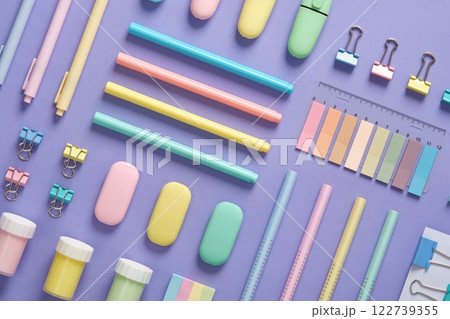 Stationery background with pastel-colored stationery neatly arranged on a light purple background. Stationery background with pastel-colored stationery neatly arranged on a light purple background. 122739355