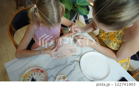 A young mother and her daughter enjoy a creative art session at home A young mother and her daughter enjoy a creative art session at home 122741903