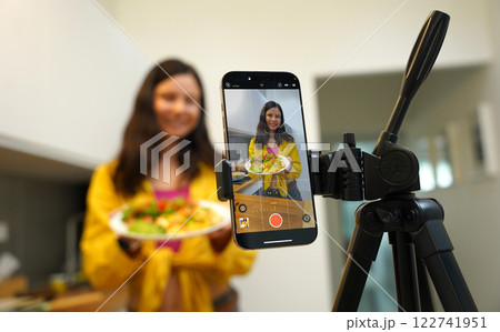 Young woman is broadcasting live from workshop how to prepare a vegetarian food 122741951