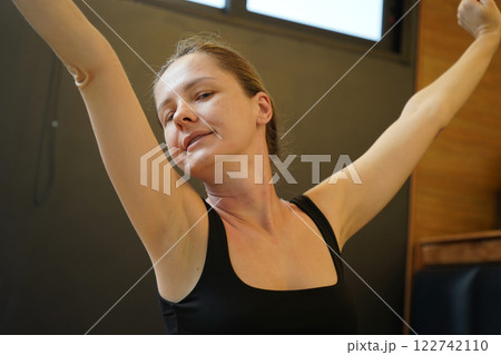 A young woman is enjoying a wonderfully serene morning in her bedroomnd A young woman is enjoying a wonderfully serene morning in her bedroomnd 122742110