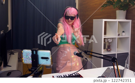 Beautiful young singer and musician broadcast from her home studio Beautiful young singer and musician broadcast from her home studio 122742351