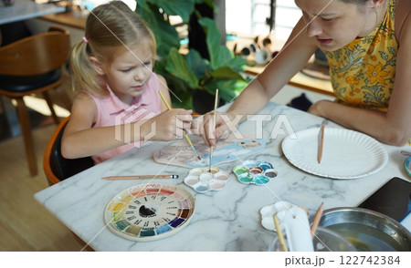 A young mother and her daughter enjoy a creative art session at home A young mother and her daughter enjoy a creative art session at home 122742384