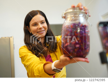 Young woman is broadcasting live from workshop how to prepare a vegetarian food Young woman is broadcasting live from workshop how to prepare a vegetarian food 122742395