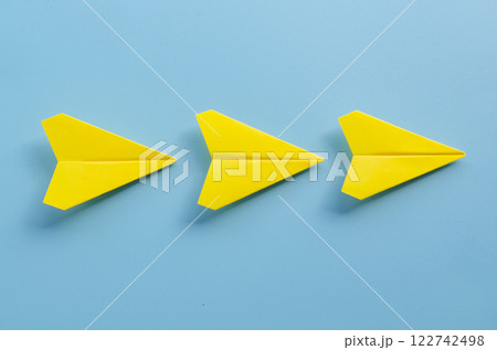 Close up view of origami yellow paper airplanes with customizable space for text Close up view of origami yellow paper airplanes with customizable space for text 122742498