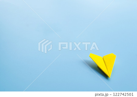 Low view of origami yellow paper airplane with customizable space for text. 122742501