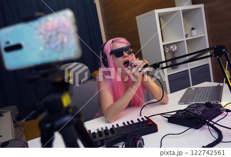 Beautiful young singer and musician broadcast from her home studio 122742561
