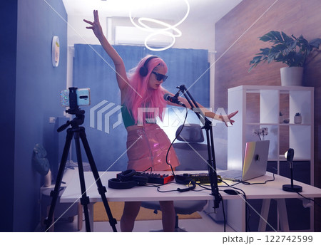 Beautiful young singer and musician broadcast from her home studio Beautiful young singer and musician broadcast from her home studio 122742599