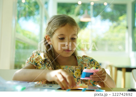 Teacher in workshop teched two girls how to assemble a thermo mosaic  122742692